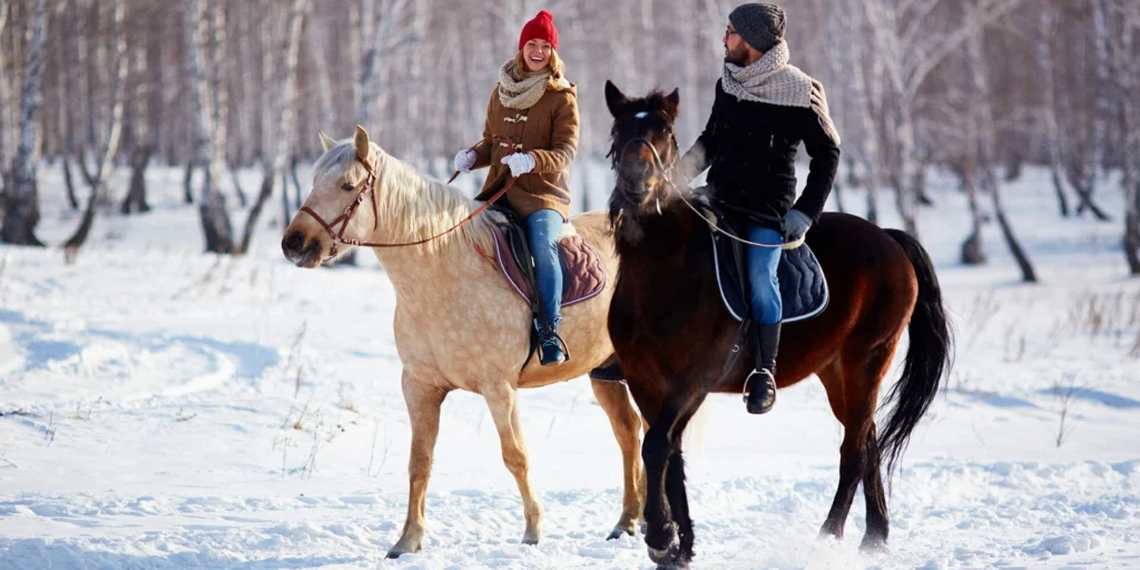 horse riding in Kyrgyzstan, man and woman are driving horse in winter