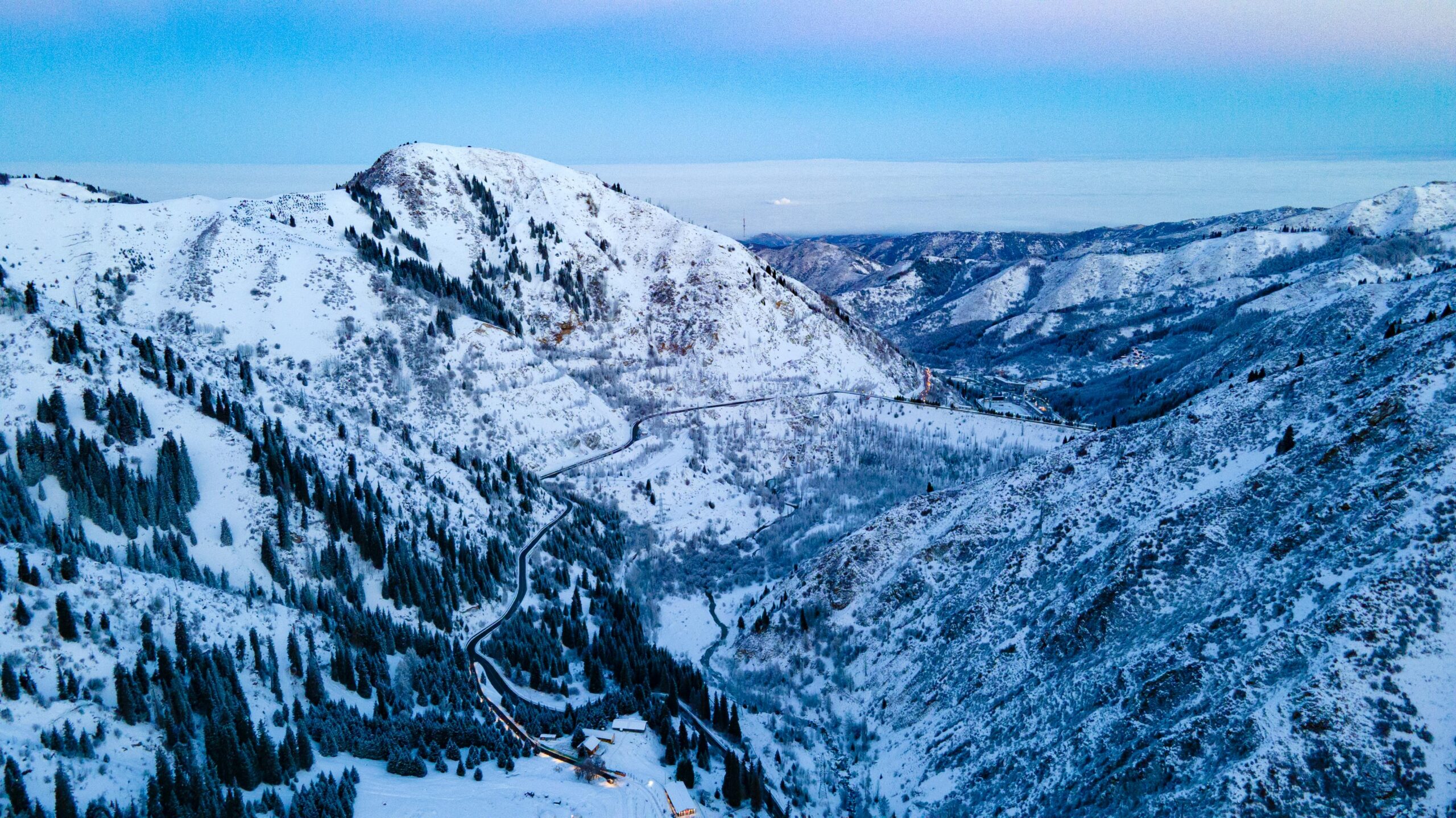 Breathtaking aerial shot of snowy mountains in Medeu, Kazakhstan during winter.