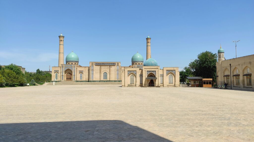 Majestic mosque with domes and minarets on a clear day in Uzbekistan.