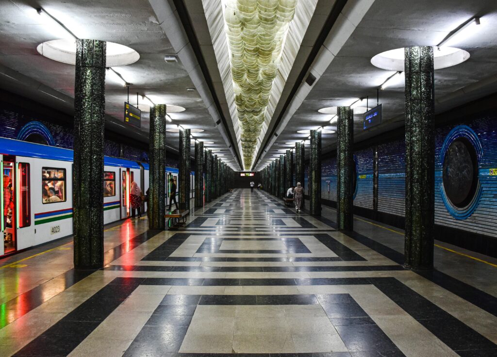 Vibrant subway station in Tashkent with intricate flooring and architectural design.