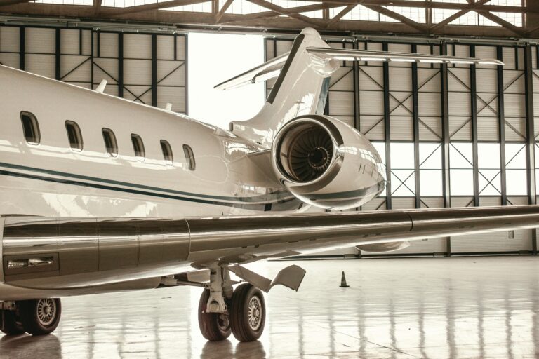 A sleek private jet parked inside a modern hangar in Paris, France.