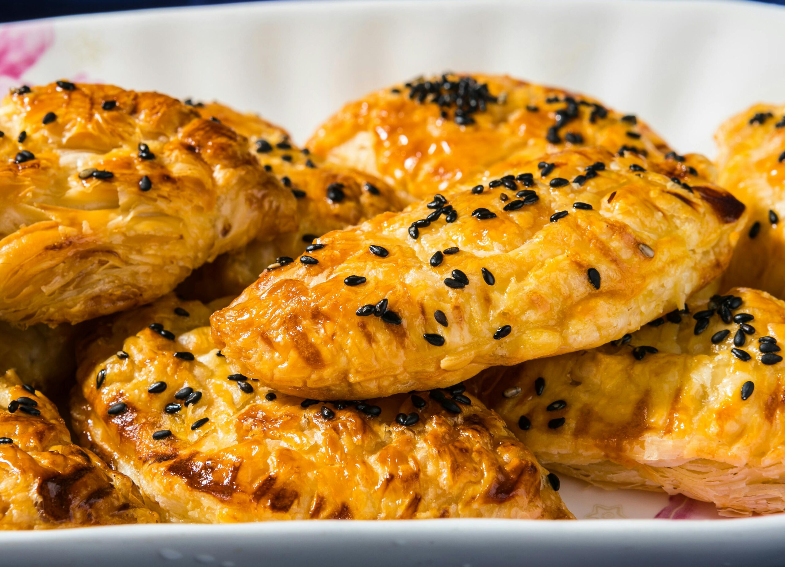 Delicious homemade pastries topped with black sesame seeds, perfect for a snack or meal.