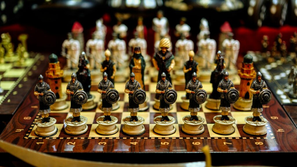 Colorful intricately designed warrior chess set on display.