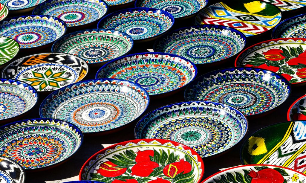 Vibrant hand-painted Uzbek ceramic plates showcasing traditional patterns in Bukhara, Uzbekistan.