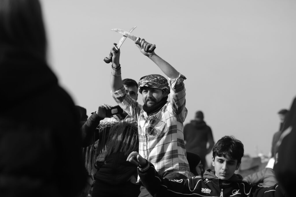A vivid black and white photo capturing a cultural performance in İzmir, Türkiye.