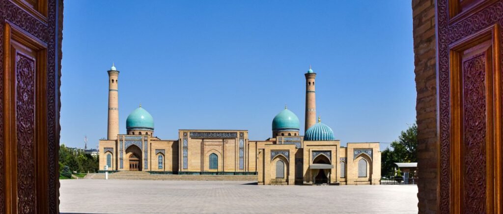 Ornate entrance view of Hazrati Imam Complex, Tashkent with clear blue sky.