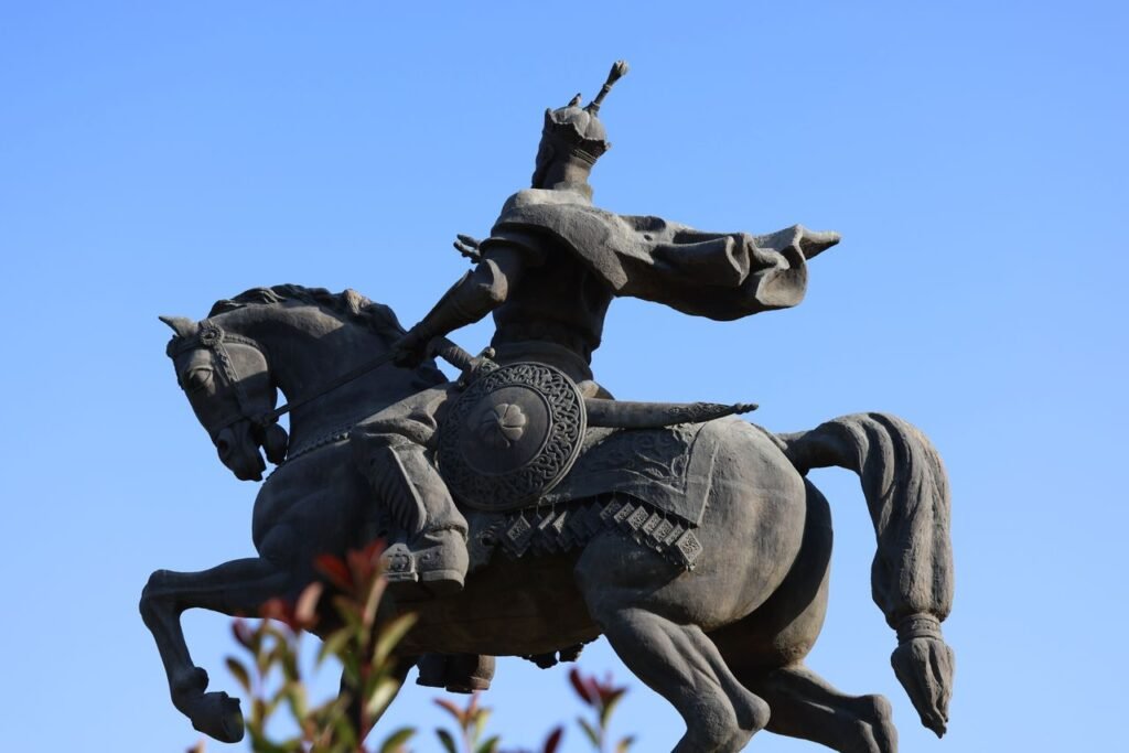 Bronze equestrian statue of Amir Temur against a clear blue sky in Tashkent, Uzbekistan.